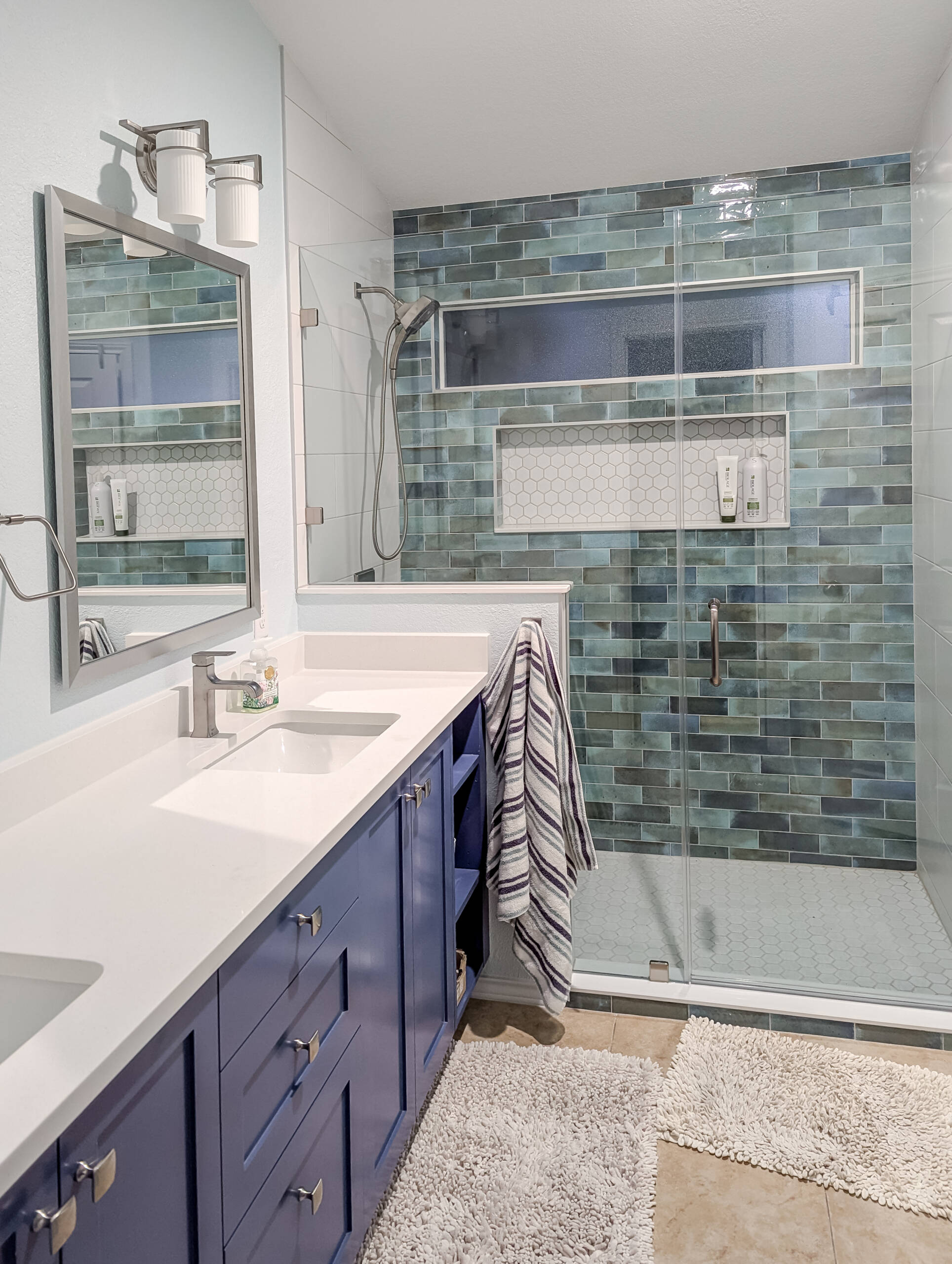 Austin bathroom remodel with blue custom cabinets